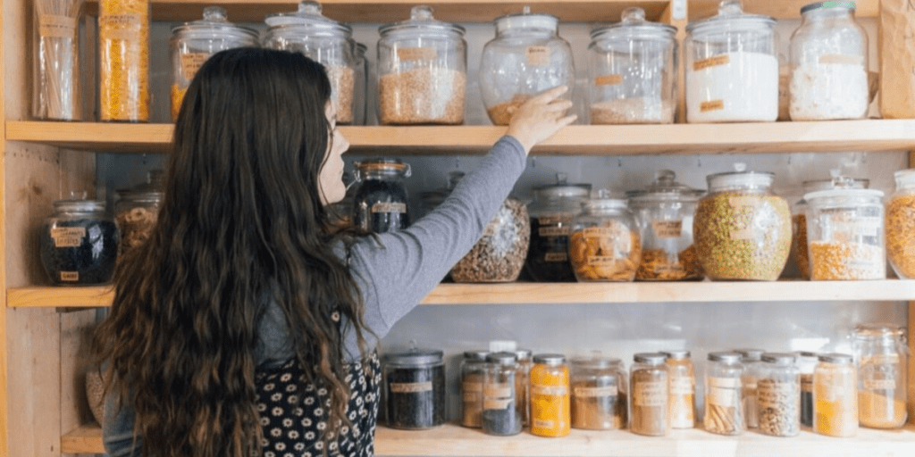 Woman checking inventory in kitchen pantry