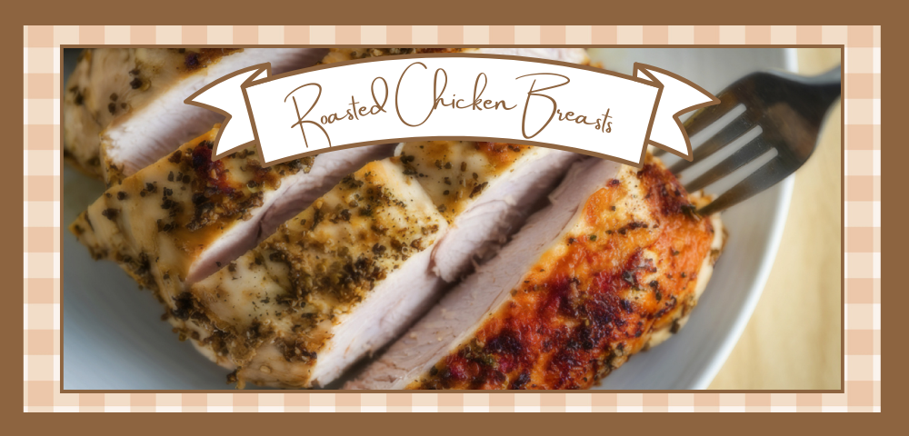 Closeup of sliced roasted chicken breasts on a white plate