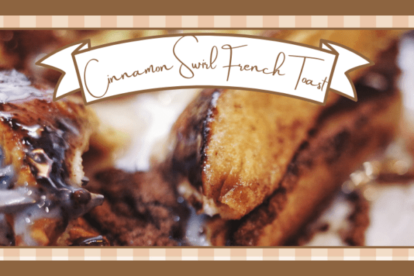 Closeup of a fork cutting into a stack of cinnamon swirl french toast