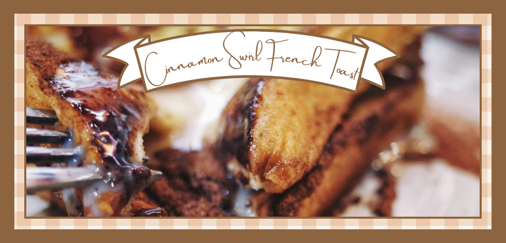 Closeup of a fork cutting into a stack of cinnamon swirl french toast