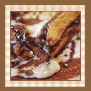 Closeup of a fork cutting into a stack of cinnamon swirl french toast
