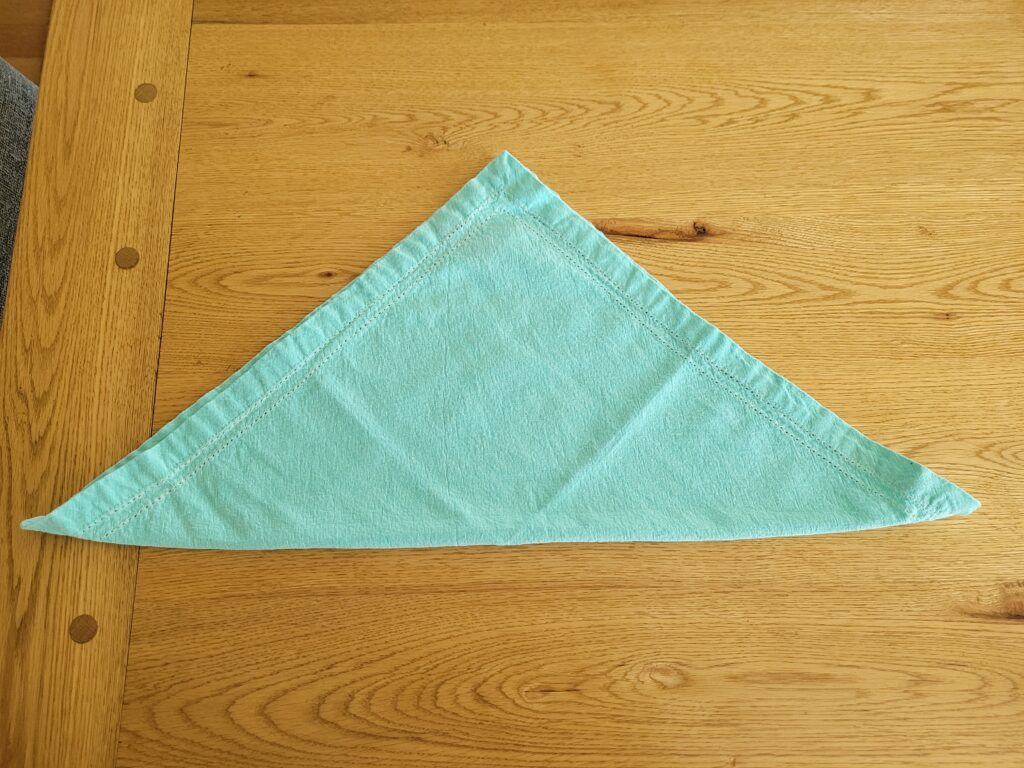 Cotton napkin folded in half like a triangle