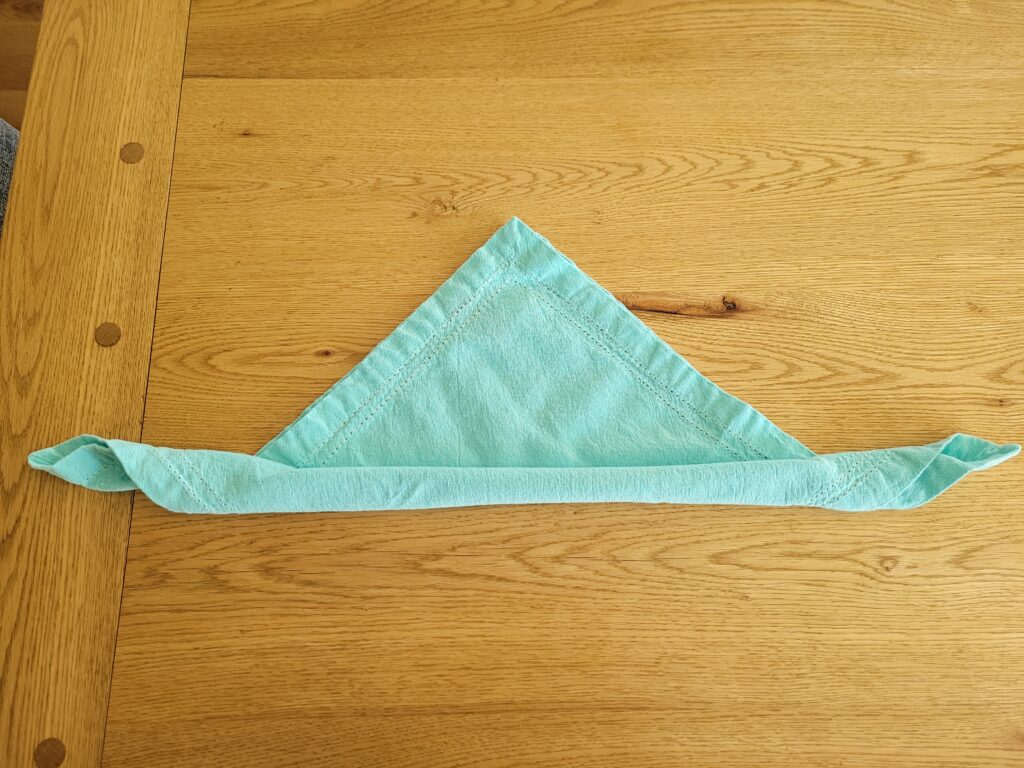 Cotton napkin triangle with half rolled up