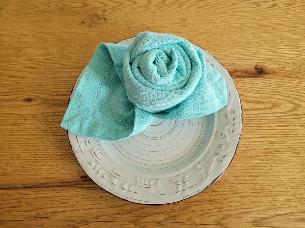 Napkin rose on a plate