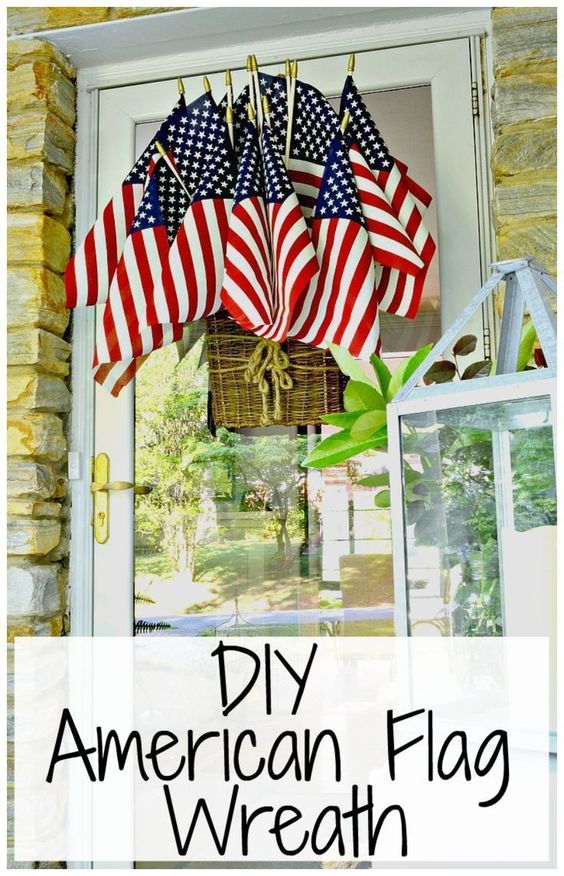 A bunch of small American flags clustered in a wicker basket and hung on a front door