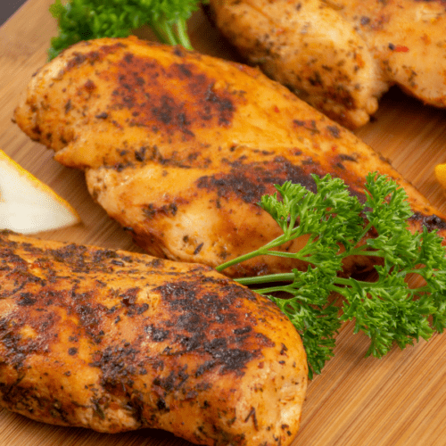 Roasted chicken breasts on a cutting board