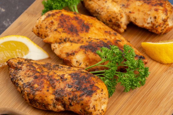 Roasted chicken breasts on a cutting board