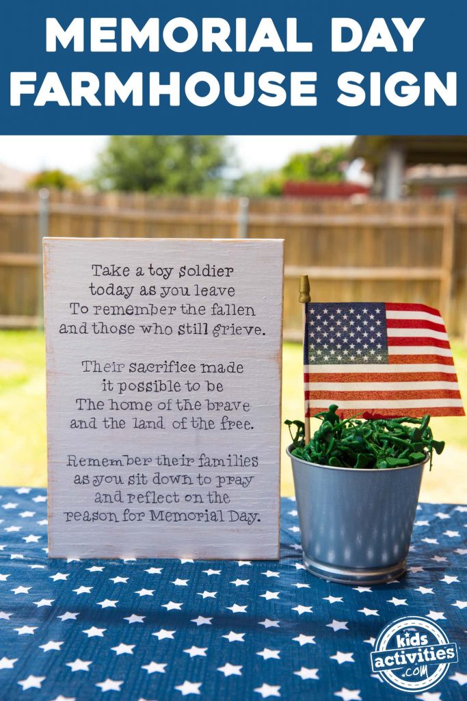 A Memorial Day sign that reads: Take a toy soldier today as you leave to remember the fallen and those who still grieve. Their sacrifice made it possible to be the home of the brave and the land of the free. Remember their families as you sit down to pray and reflect on the reason for Memorial Day. The sign is next to a pail with plastic toy soldiers and a small American flag.