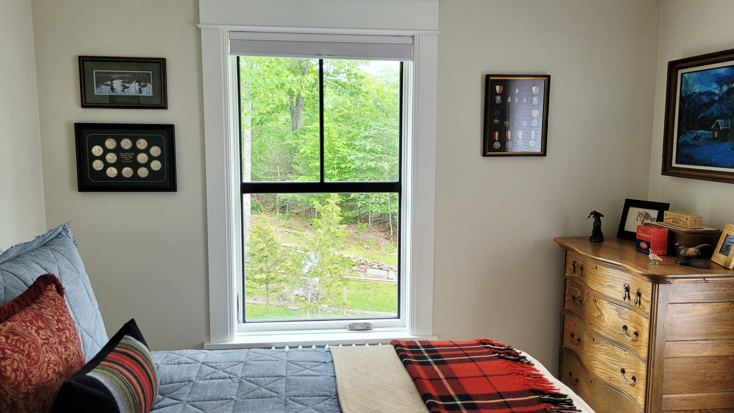 View of the guest room featuring one of two big windows.