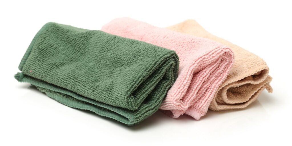 Green, pink, and buff colored microfiber cloths.