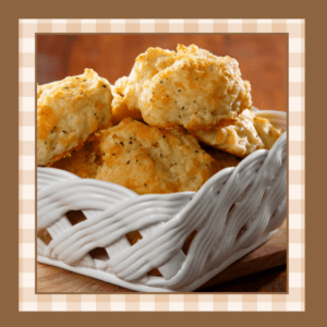 Stack of cheddar bay biscuits in a white ceramic basket