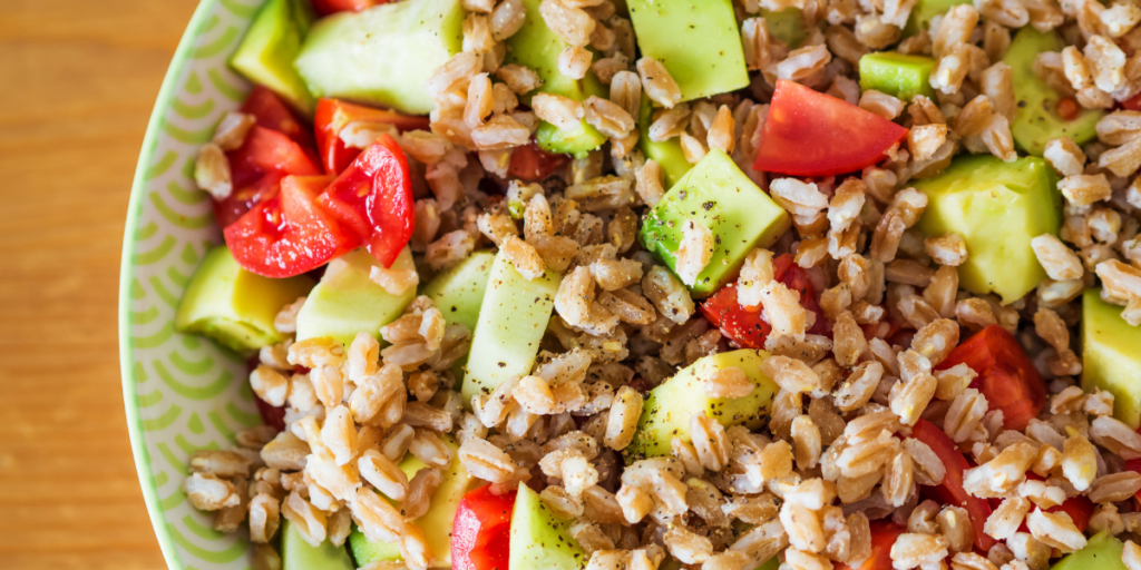 Close up of farro salad in a green bowl