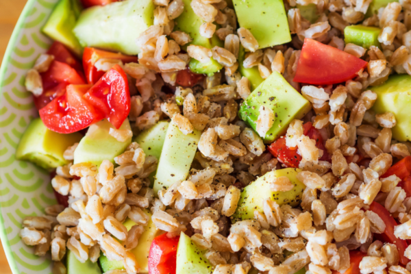 Close up of farro salad in a green bowl