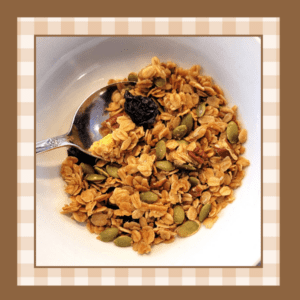 White ceramic bowl of granola with a spoon in it