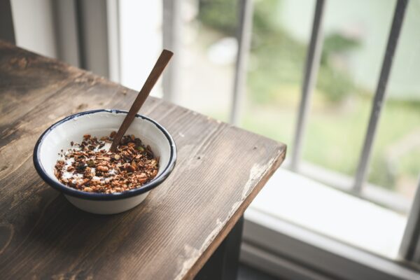 Bowl of granola on a wooden table.