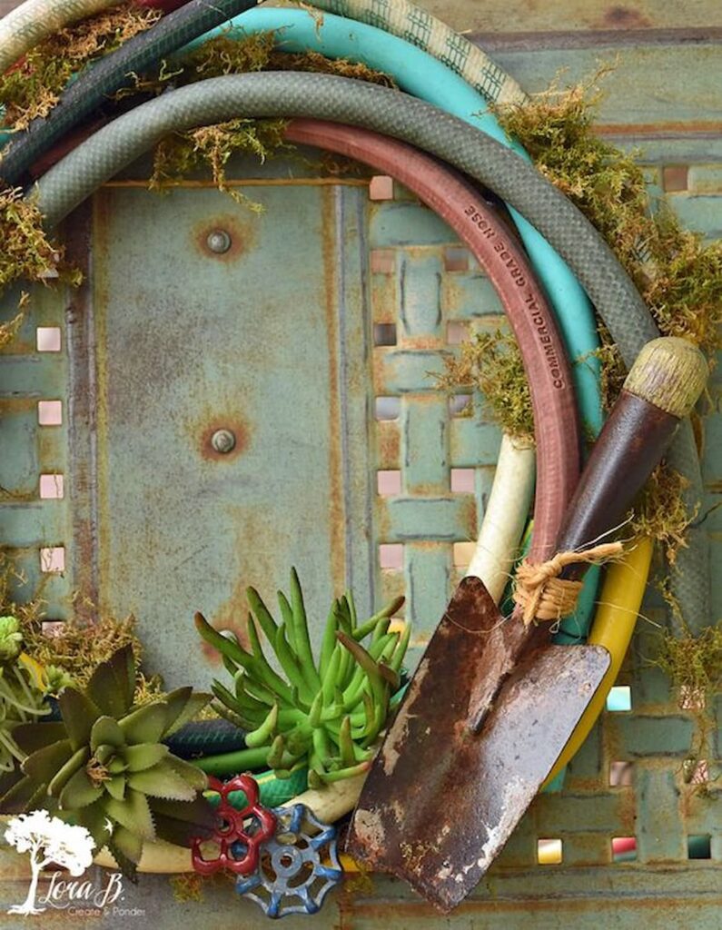 Garden hose wreath hanging on a rusty metal grate.