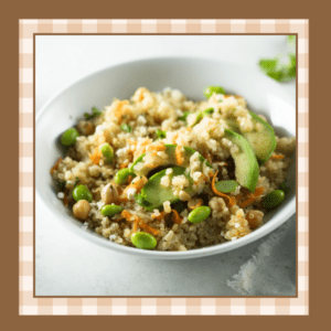 White bowl with edamame quinoa salad including chickpeas and avocado