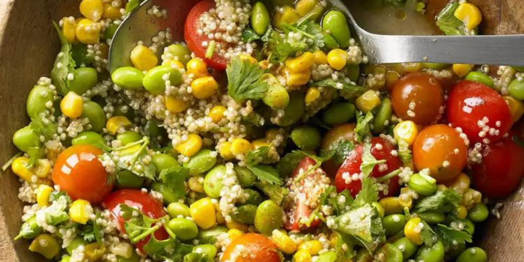 Wooden salad bowl with edamame quinoa salad