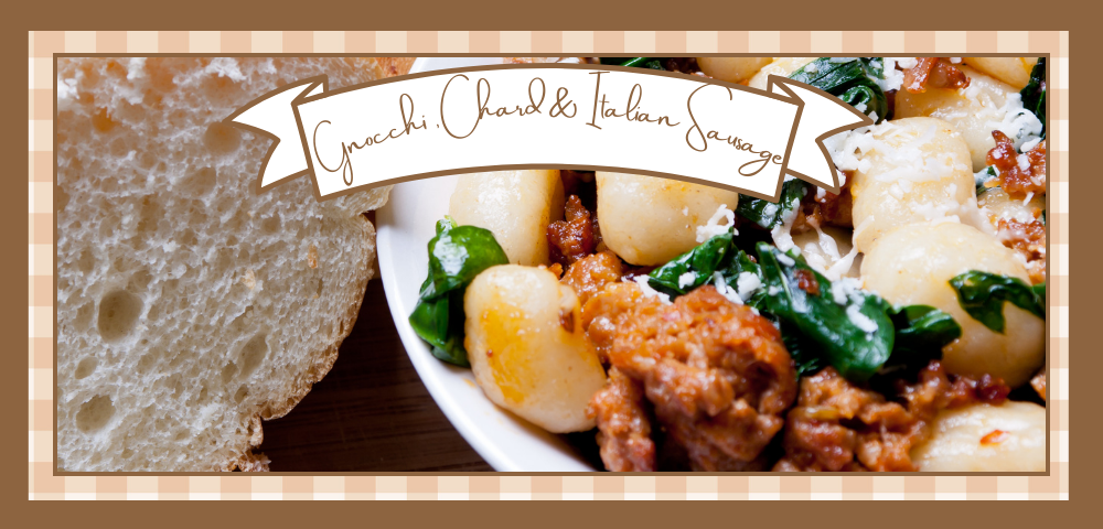 Bowl of gnocchi, chard and Italian sausage with bread on the side