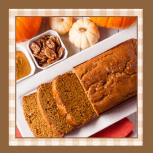 Loaf of pumpkin bread with three slices on a white plate