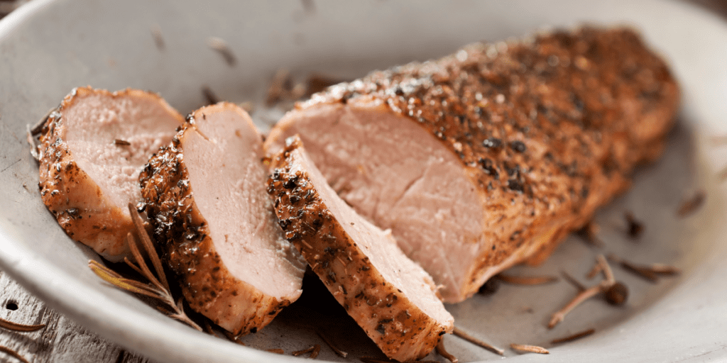 Sliced pork tenderloin on a white plate