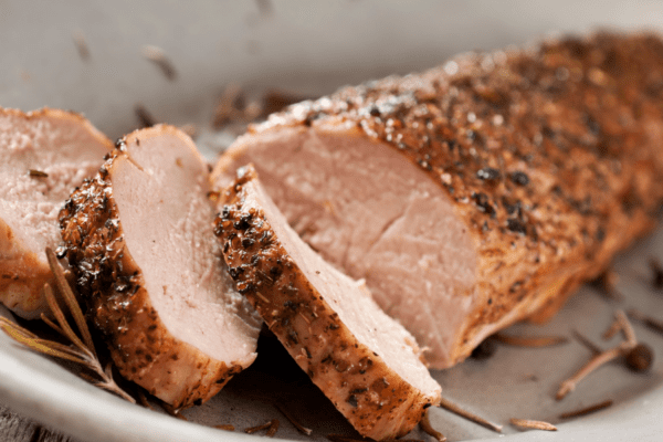 Sliced pork tenderloin on a white plate