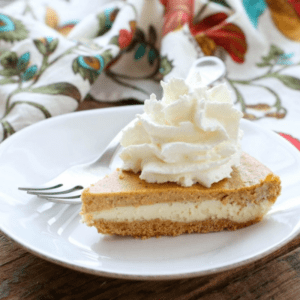 Slice of pumpkin pie cheesecake on a white plate.