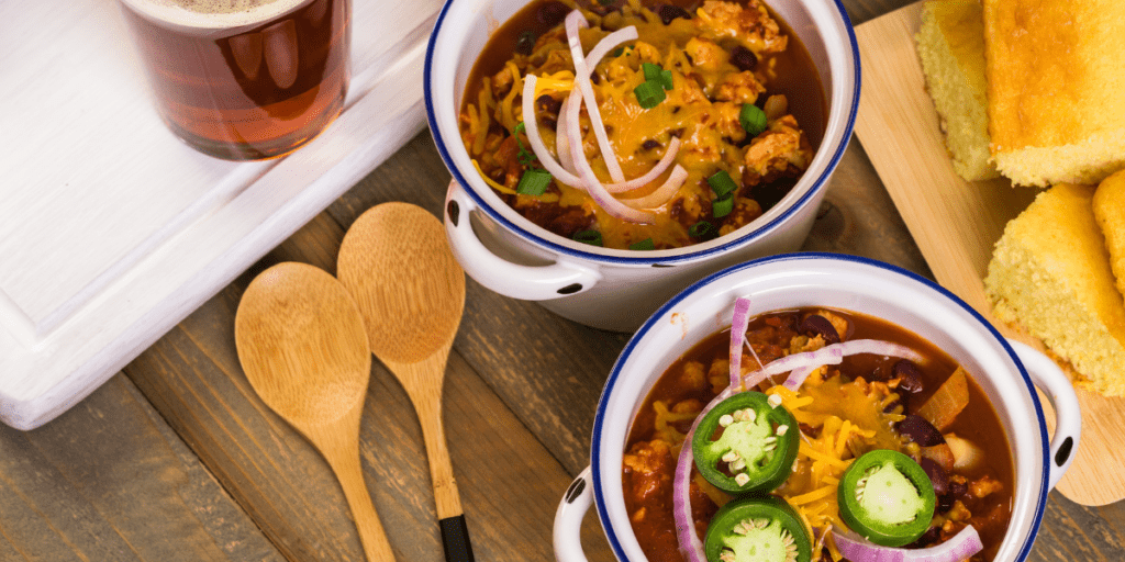 Turkey chili served in individual white crocks.