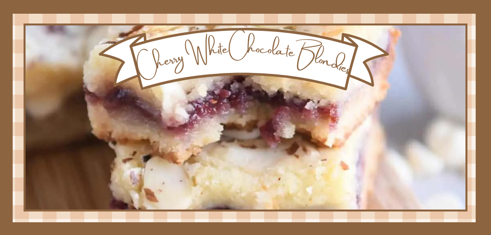 Two cherry filled white chocolate blondies stacked one on the other
