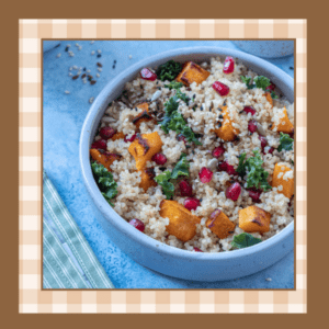 Bowl of quinoa butternut squash salad on a blue counter