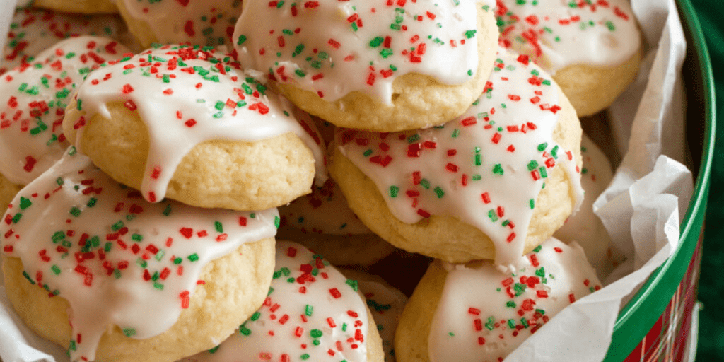 Holiday tin filled with Italian sugar cookies decorated with red and green sprinkles.