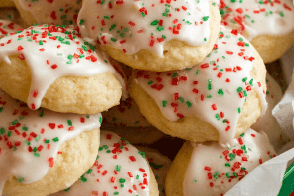 Holiday tin filled with Italian sugar cookies decorated with red and green sprinkles.