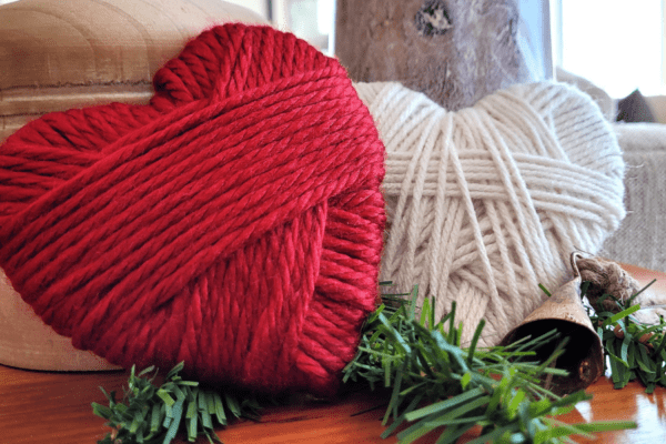 8-Valentine's-Decorations-Banner | The Granite Acorn Two yarn wrapped hearts   one red and one ivory   set against two wooden candle holders