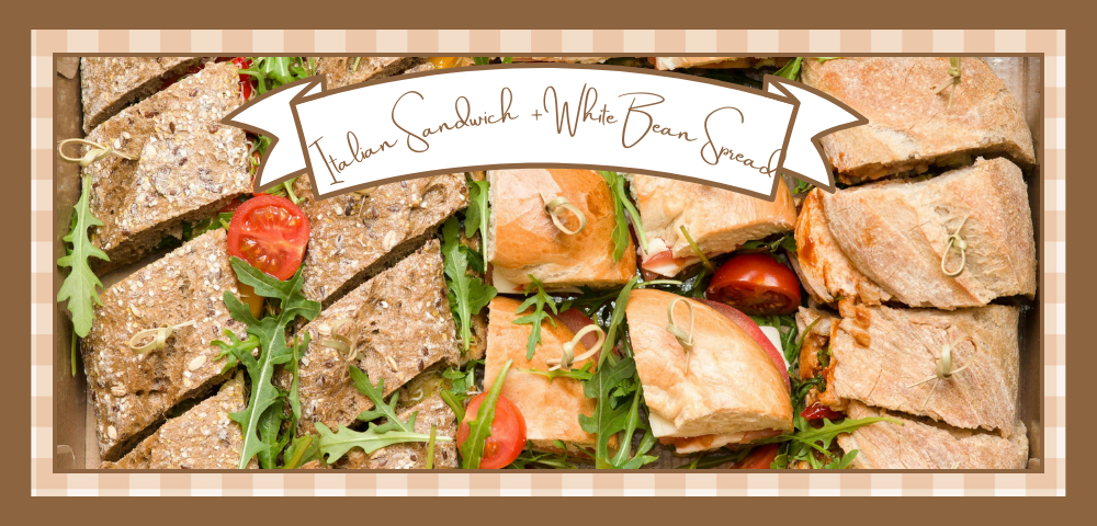 Vegan Italian sandwiches on Italian bread cut into individual servings and garnished with greens and tomatoes