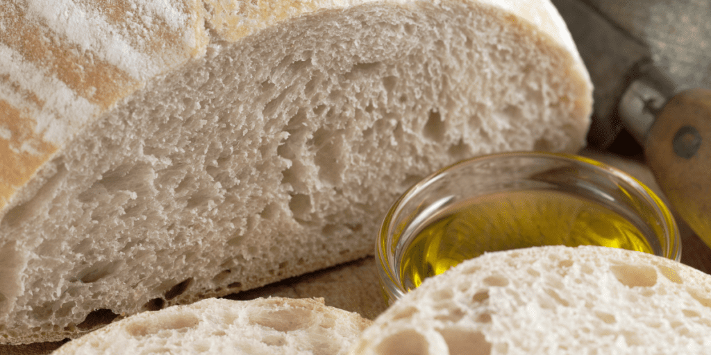 Loaf of Italian bread with olive oil for dipping.