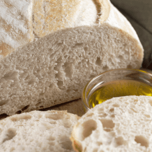 Sliced Italian bread with olive oil for dipping.