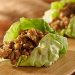 Closeup of a lettuce wrap filled with tofu filling.