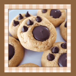 Paw-Prints-Recipe | The Granite Acorn Plate of peanut butter cookies with paw prints pressed into the tops using a chocolate wafer and three chocolate chips