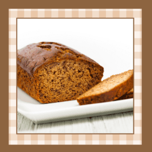 Loaf of banana bread with two slices removed to show the inside of the bread