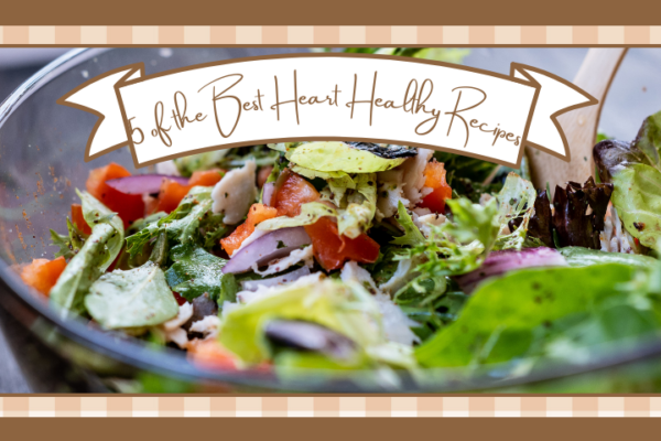 Closeup of clear bowl of mixed greens against a dark background