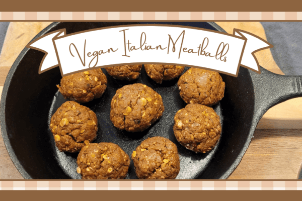 Skillet of vegan italian meatballs on a wood cutting board