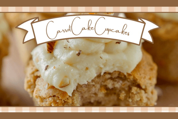 Closeup of a carrot cake cupcake with cream cheese frosting and a sprinkle of nuts A bite has been taken out of it