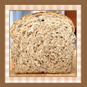 Multigrain-Bread-Recipe | The Granite Acorn Loaf of multigrain bread sliced so it's shows the inside