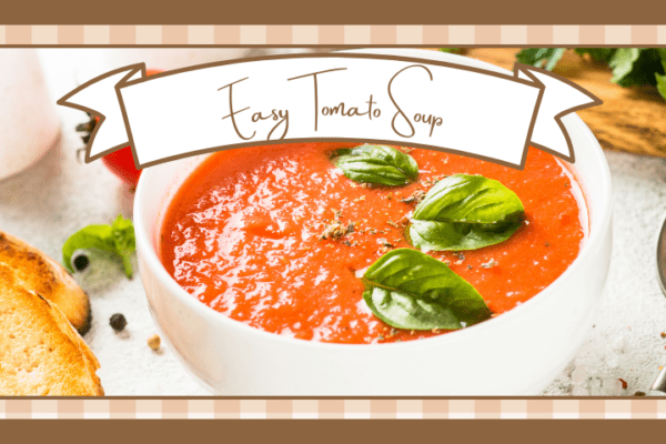 Bowl of tomato soup garnished with fresh basil leaves