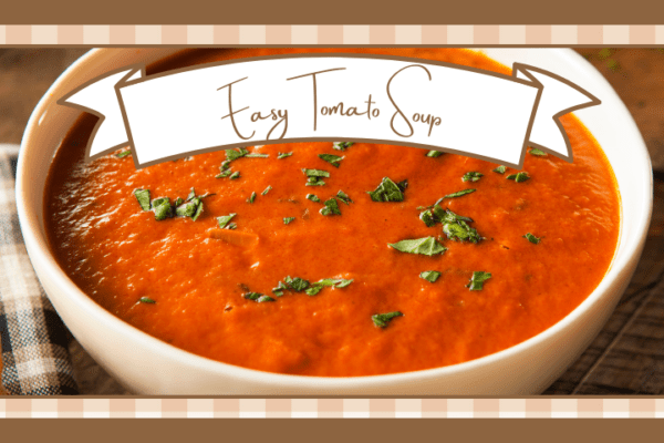 Bowl of tomato soup garnished with chopped fresh herbs