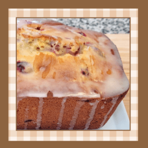 Cranberry-Orange-Recipe | The Granite Acorn Closeup of a loaf of cranberry orange bread