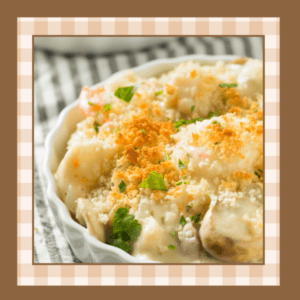 Baking dish of baked sea scallops with cracker crumb topping