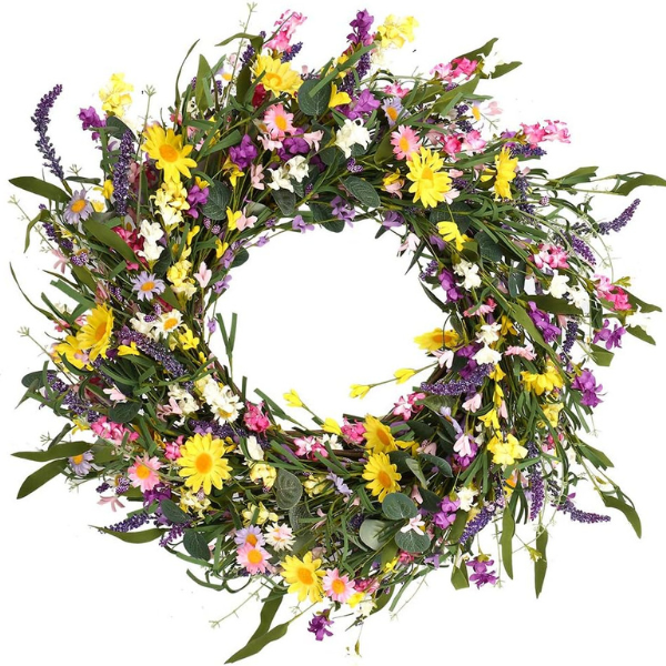 Spring wreath with yellow pink and white flowers on a base of faux green leaves