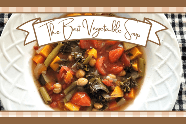 Bowl of vegetable soup on a black and white checked placemat