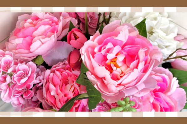Bunch of pink peonies snapdragons tulips and a white hydrangea blossom